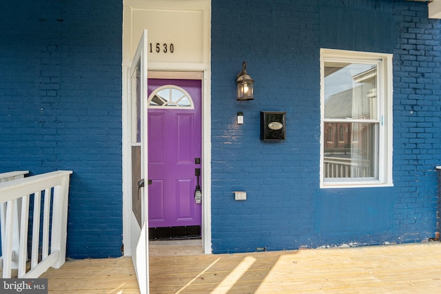 property entrance featuring brick siding