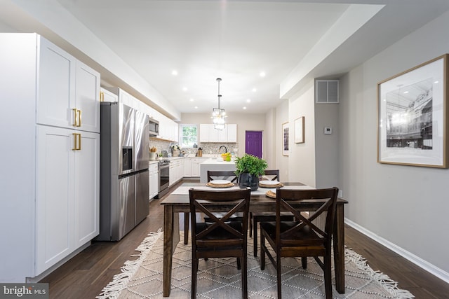 dining space featuring baseboards, visible vents, dark wood finished floors, a chandelier, and recessed lighting