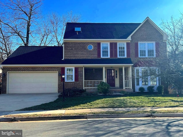 traditional home with brick siding, a porch, a garage, driveway, and a front lawn