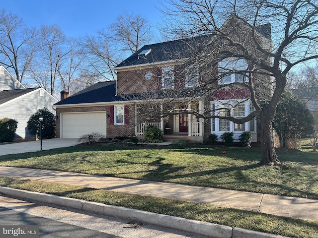 view of front of house featuring a front lawn, brick siding, driveway, and an attached garage