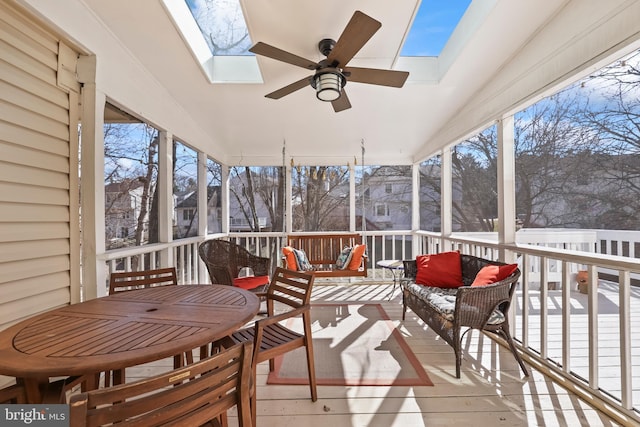 sunroom / solarium with lofted ceiling with skylight and ceiling fan