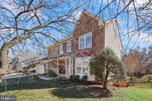 view of front of house featuring brick siding and a front lawn