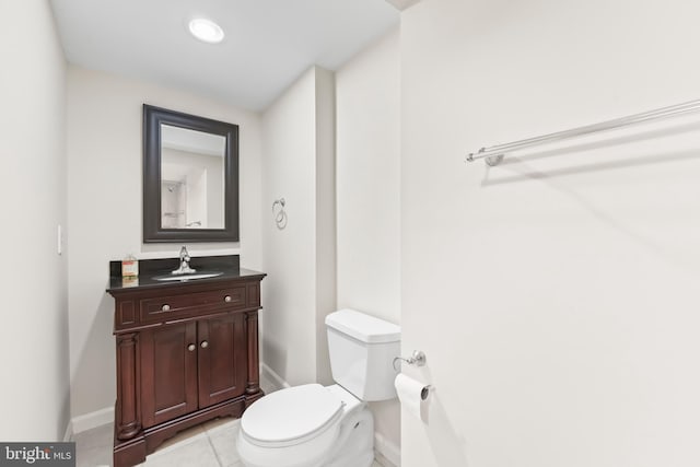 bathroom with baseboards, toilet, tile patterned floors, vanity, and recessed lighting