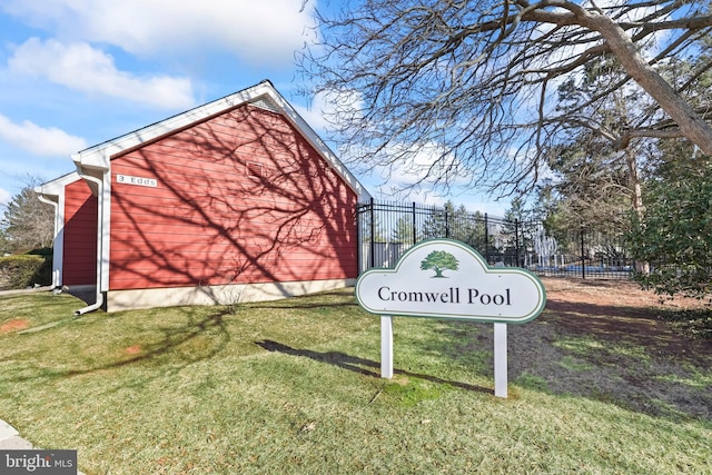 view of community featuring fence and a lawn