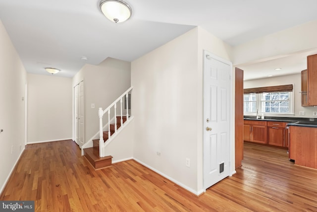 interior space with wood finished floors and baseboards