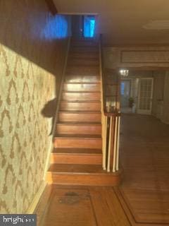 stairway with wood finished floors