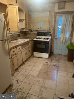 kitchen featuring white appliances, light tile patterned flooring, and a sink