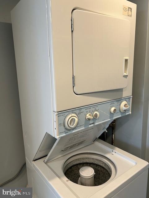 laundry room featuring laundry area and stacked washer / dryer