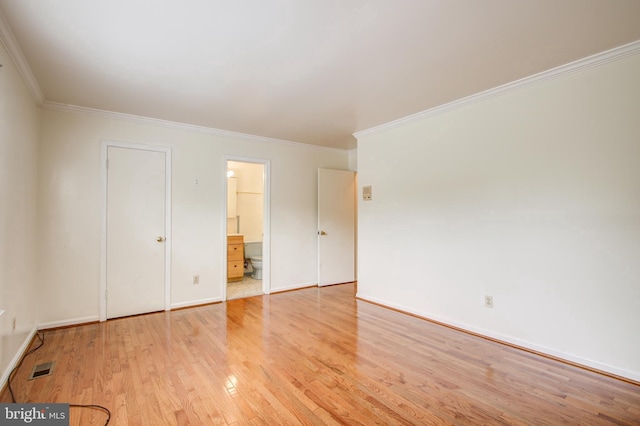 unfurnished bedroom with crown molding, baseboards, visible vents, and light wood-style floors