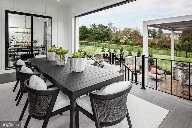 exterior space featuring a decorative wall and wood finished floors