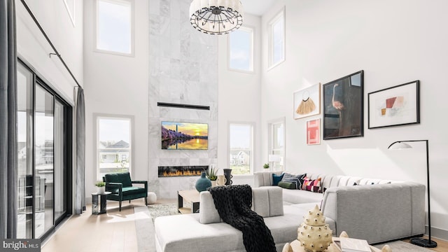 living room featuring a healthy amount of sunlight, a fireplace, and wood finished floors