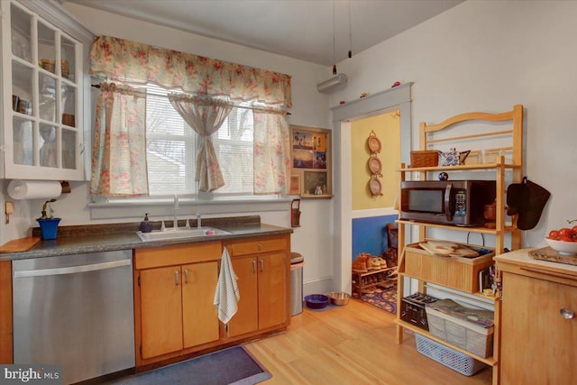17035 Virginia Ave, Williamsport, MD 21795 - kitchen with light wood-type flooring, glass insert cabinets, dark countertops, stainless steel appliances, and a sink
