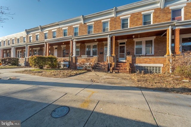 townhome / multi-family property featuring brick siding