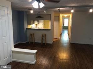 interior space with ceiling fan and wood finished floors