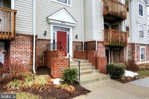 view of exterior entry featuring brick siding