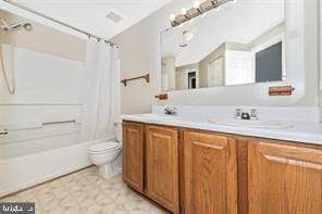 full bathroom featuring vanity, shower / bath combo with shower curtain, toilet, and tile patterned floors