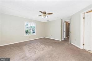 unfurnished room with carpet floors, ceiling fan, and baseboards