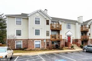 view of building exterior with uncovered parking