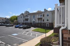 view of community featuring uncovered parking and a residential view