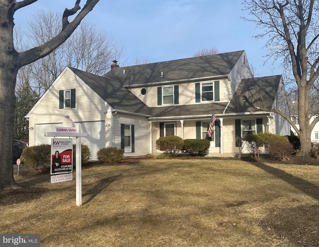 traditional-style home with a chimney and a front yard