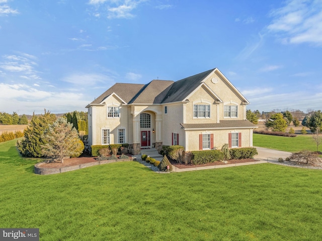 view of front of property featuring a front lawn and stucco siding