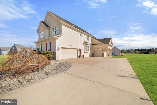 view of side of home featuring a lawn, driveway, and an attached garage