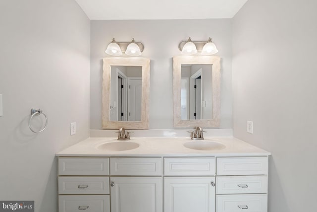 bathroom with a sink and double vanity