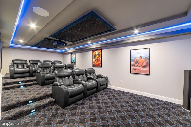 carpeted home theater featuring baseboards