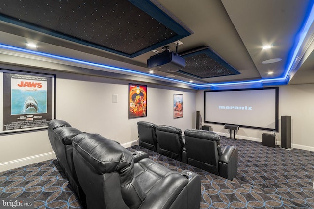 home theater room with carpet, baseboards, a raised ceiling, and recessed lighting