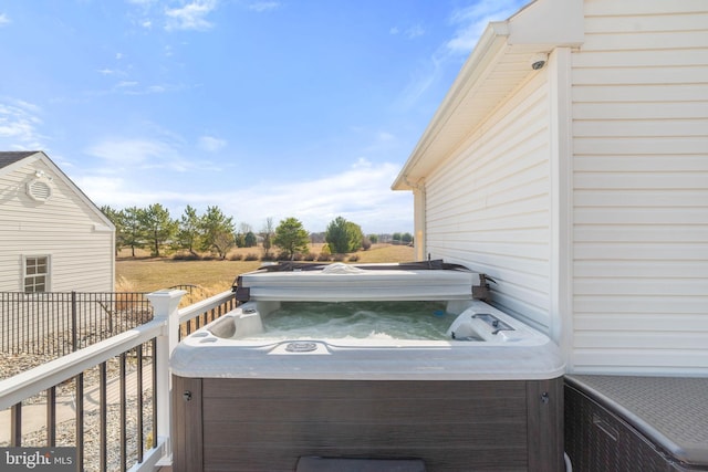 exterior space featuring fence and a hot tub