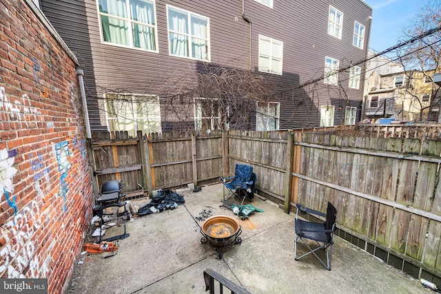 view of patio / terrace featuring a fire pit and fence