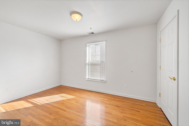 unfurnished bedroom with light wood-type flooring, visible vents, and baseboards