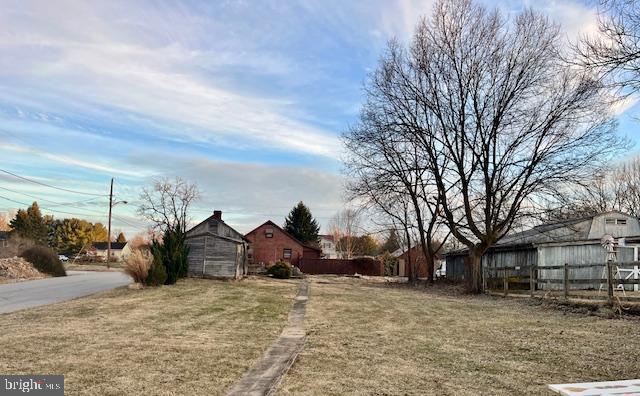 view of yard with fence and an outdoor structure