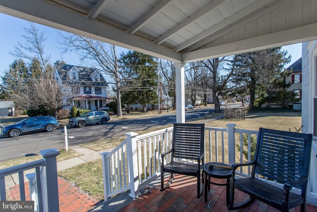 wooden deck featuring a residential view and a porch