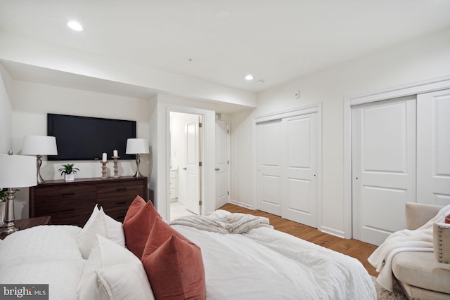 bedroom featuring multiple closets, recessed lighting, light wood-style flooring, connected bathroom, and baseboards