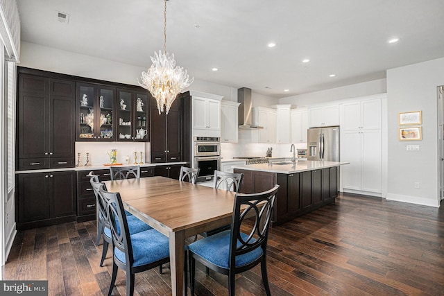 dining room featuring a notable chandelier, recessed lighting, dark wood-style flooring, visible vents, and baseboards