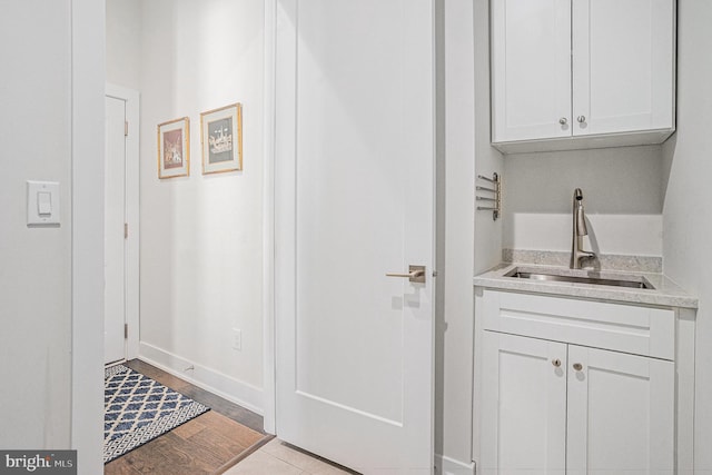 interior space featuring baseboards and a sink