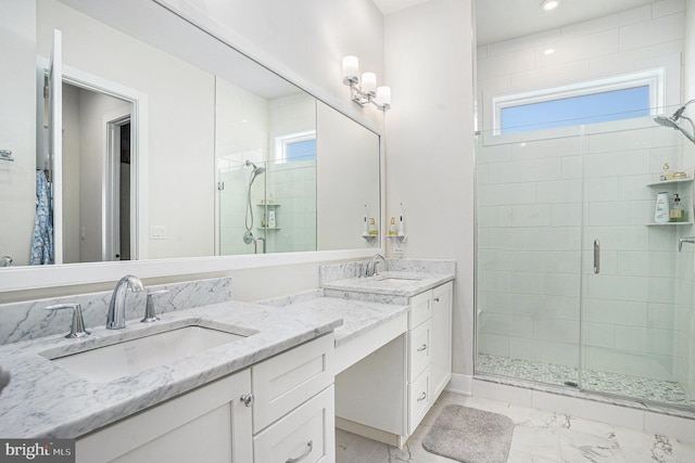 bathroom with marble finish floor, plenty of natural light, a shower stall, and vanity