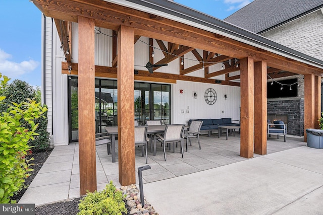 view of patio / terrace with an outdoor living space with a fireplace