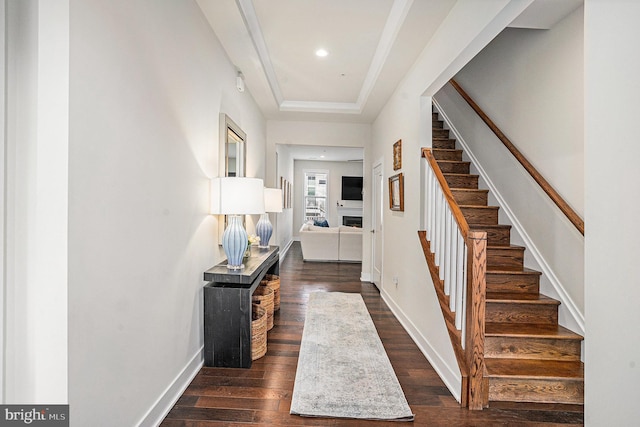 foyer entrance featuring recessed lighting, baseboards, stairway, a tray ceiling, and dark wood finished floors