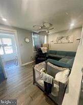 living room featuring wood finished floors and baseboards