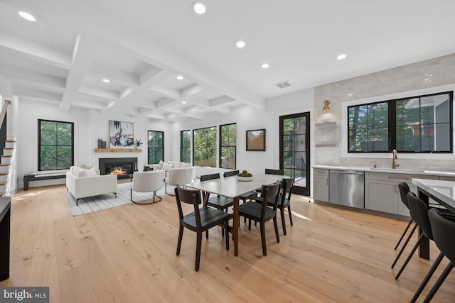6807 29th St N, Arlington, VA 22213 - dining room featuring recessed lighting, beam ceiling, light wood-style flooring, a glass covered fireplace, and plenty of natural light