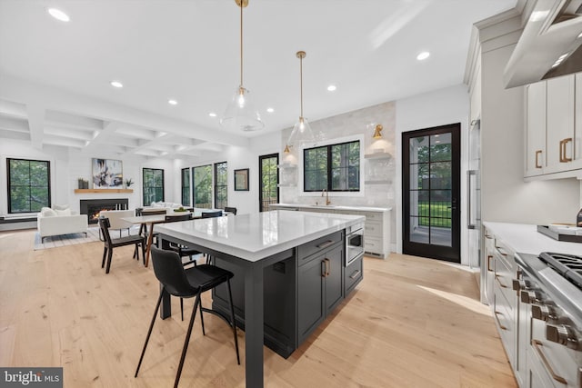 6807 29th St N, Arlington, VA 22213 - kitchen featuring recessed lighting, exhaust hood, light countertops, light wood finished floors, and beam ceiling