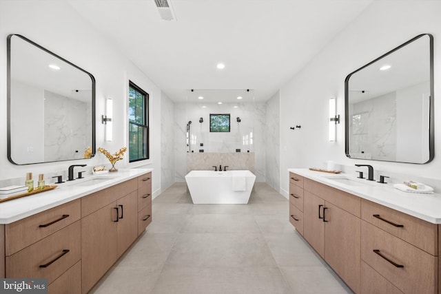 6807 29th St N, Arlington, VA 22213 - bathroom featuring recessed lighting, two vanities, a soaking tub, and a marble finish shower