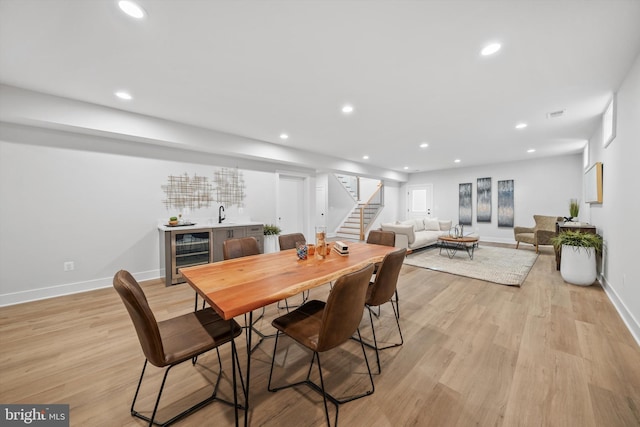 6807 29th St N, Arlington, VA 22213 - dining space with wine cooler, wet bar, stairway, recessed lighting, and light wood-style flooring