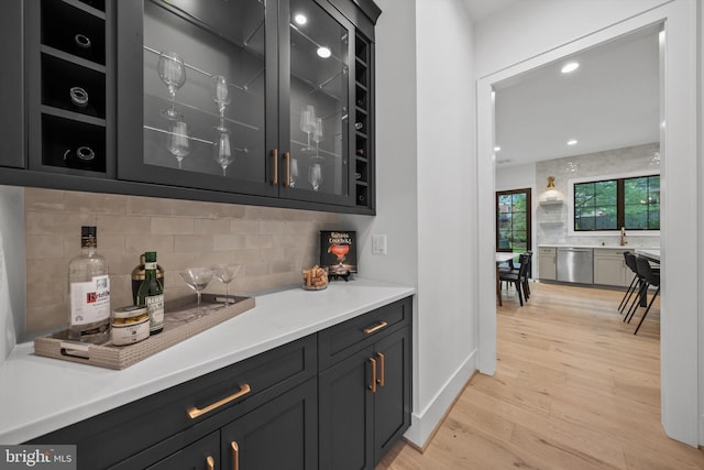 6807 29th St N, Arlington, VA 22213 - indoor bar with stainless steel dishwasher, light wood-style floors, decorative backsplash, and recessed lighting