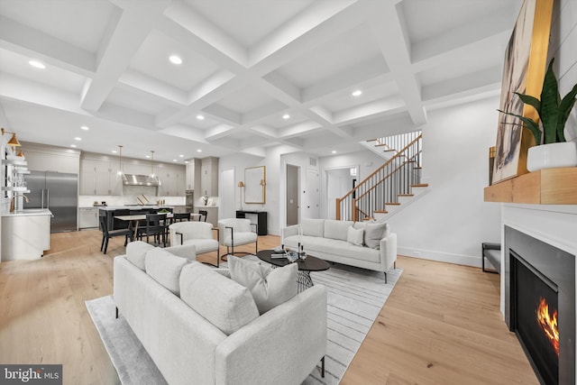 6807 29th St N, Arlington, VA 22213 - living area featuring a lit fireplace, recessed lighting, beam ceiling, stairs, and light wood-style flooring