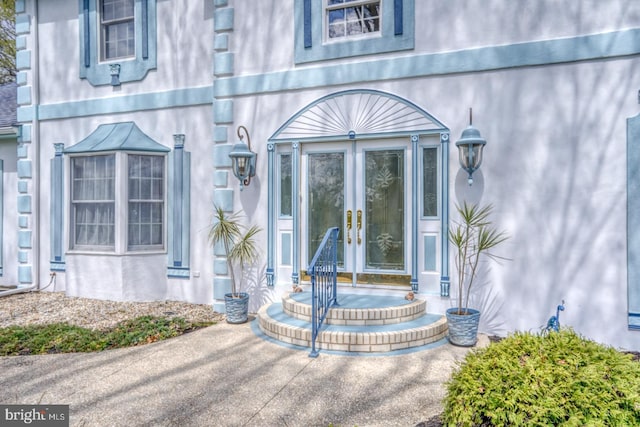 doorway to property with french doors and stucco siding