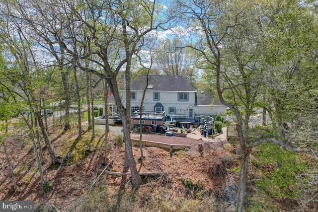 back of property with a wooden deck