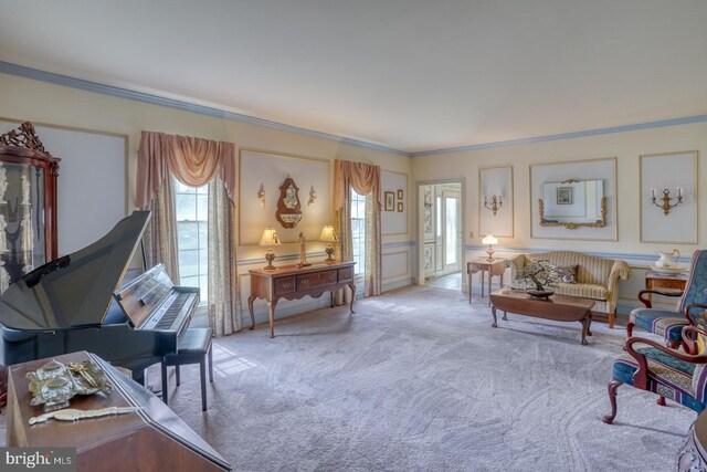 carpeted living area featuring crown molding, a decorative wall, and a healthy amount of sunlight